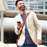 smiling-mature-man-outdoors-with-mobile-phone
